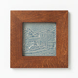 Decorative ceramic tile in blue glaze of Cincinnati Coney Island in Golden Oak Frame