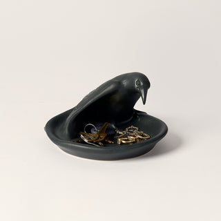 Black bird trinket dish filled with keys and jewelry.