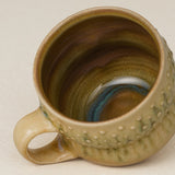 Close-up details of hand-thrown mug by Rookwood
