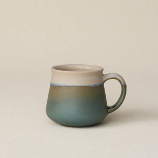 Hand-thrown ceramic mug by Rookwood Pottery