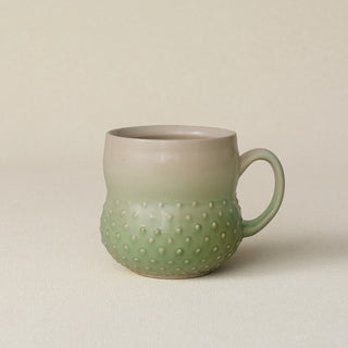 Hand-thrown ceramic mug by Rookwood Pottery