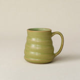 Hand-thrown ceramic mug by Rookwood Pottery
