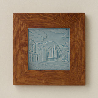 Rookwood Union Terminal City Scene art tile in a golden oak wood frame