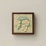 Sculpted decorative tile in wood frame by Rookwood