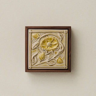 Sculpted decorative tile in wood frame by Rookwood