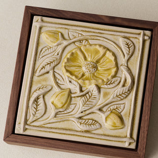 Close-up details of the sculpted tile, with visible carvings and layered glaze.