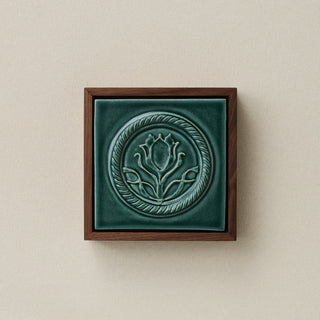 Sculpted decorative tile in wood frame by Rookwood