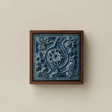 Sculpted decorative tile in wood frame by Rookwood