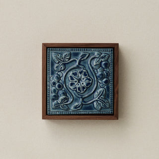 Sculpted decorative tile in wood frame by Rookwood