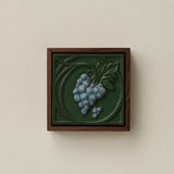 Sculpted decorative tile in wood frame by Rookwood
