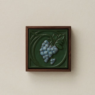 Sculpted decorative tile in wood frame by Rookwood