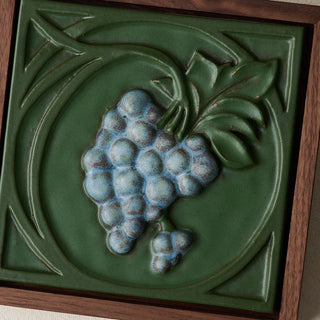 Close-up details of the sculpted tile, with visible carvings and layered glaze.