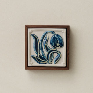 Sculpted decorative tile in wood frame by Rookwood
