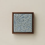 Sculpted decorative tile in wood frame by Rookwood