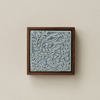 Sculpted decorative tile in wood frame by Rookwood