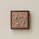 Sculpted decorative tile in wood frame by Rookwood