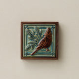 Sculpted decorative tile in wood frame by Rookwood