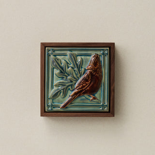 Sculpted decorative tile in wood frame by Rookwood