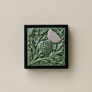 Sculpted decorative tile in wood frame by Rookwood