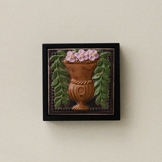 Sculpted decorative tile in wood frame by Rookwood