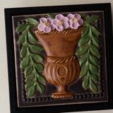 Close-up details of the sculpted tile, with visible carvings and layered glaze.