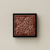 Sculpted decorative tile in wood frame by Rookwood