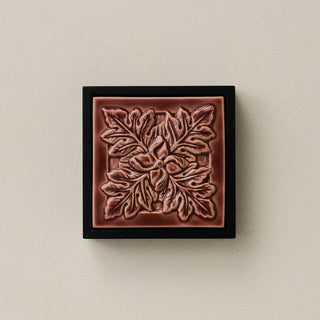 Sculpted decorative tile in wood frame by Rookwood