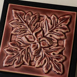 Close-up details of the sculpted tile, with visible carvings and layered glaze.