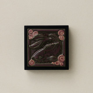 Sculpted decorative tile in wood frame by Rookwood