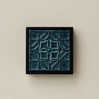 Sculpted decorative tile in wood frame by Rookwood