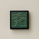 Sculpted decorative tile in wood frame by Rookwood