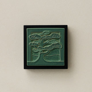 Sculpted decorative tile in wood frame by Rookwood
