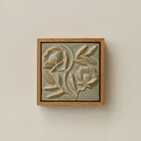 Sculpted decorative tile in wood frame by Rookwood