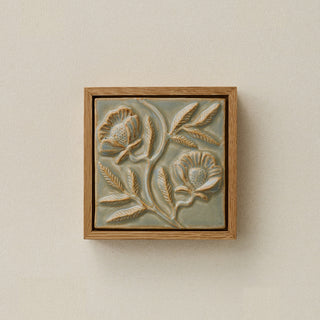 Sculpted decorative tile in wood frame by Rookwood