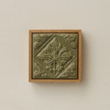 Sculpted decorative tile in wood frame by Rookwood