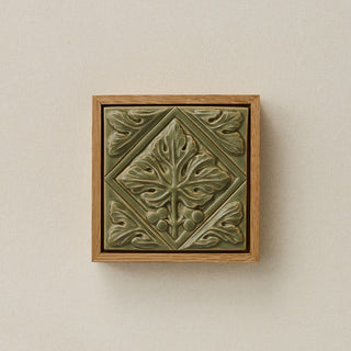 Sculpted decorative tile in wood frame by Rookwood