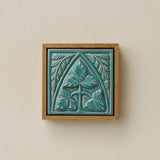 Sculpted decorative tile in wood frame by Rookwood