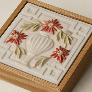 Close-up details of the sculpted tile, with visible carvings and layered glaze.
