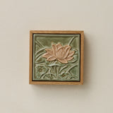 Sculpted decorative tile in wood frame by Rookwood
