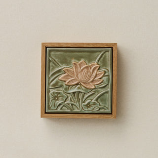 Sculpted decorative tile in wood frame by Rookwood