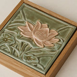 Close-up details of the sculpted tile, with visible carvings and layered glaze.