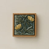 Sculpted decorative tile in wood frame by Rookwood