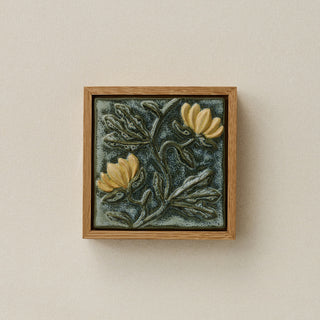 Sculpted decorative tile in wood frame by Rookwood