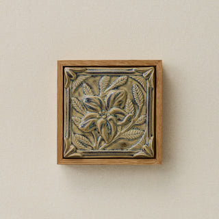Sculpted decorative tile in wood frame by Rookwood