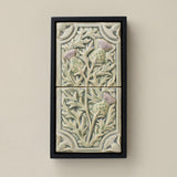 Sculpted decorative tile in wood frame by Rookwood