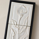 Close-up details of the sculpted tile, with visible carvings and layered glaze.