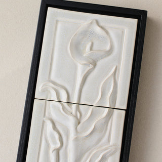 Close-up details of the sculpted tile, with visible carvings and layered glaze.