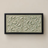 Sculpted decorative tile in wood frame by Rookwood