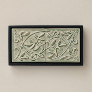 Sculpted decorative tile in wood frame by Rookwood