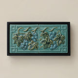 Sculpted decorative tile in wood frame by Rookwood